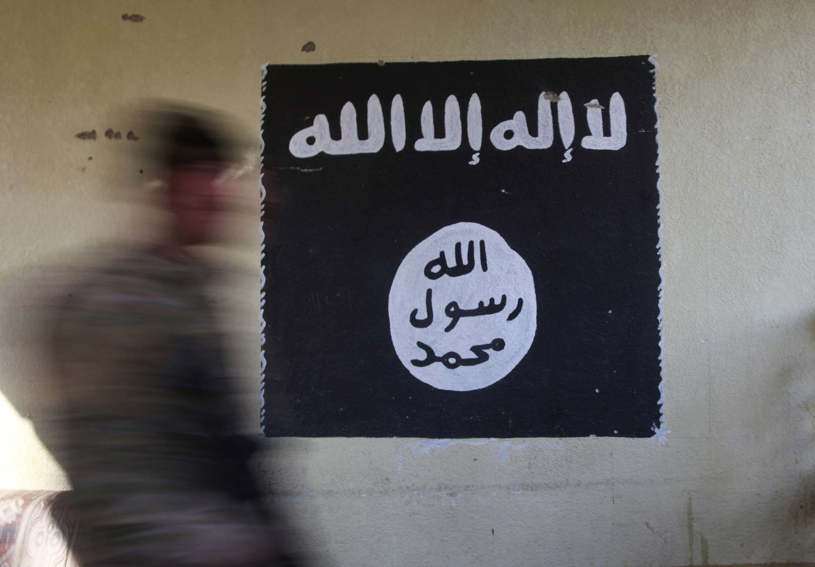 A wall painted with the black flag commonly used by Islamic State militants