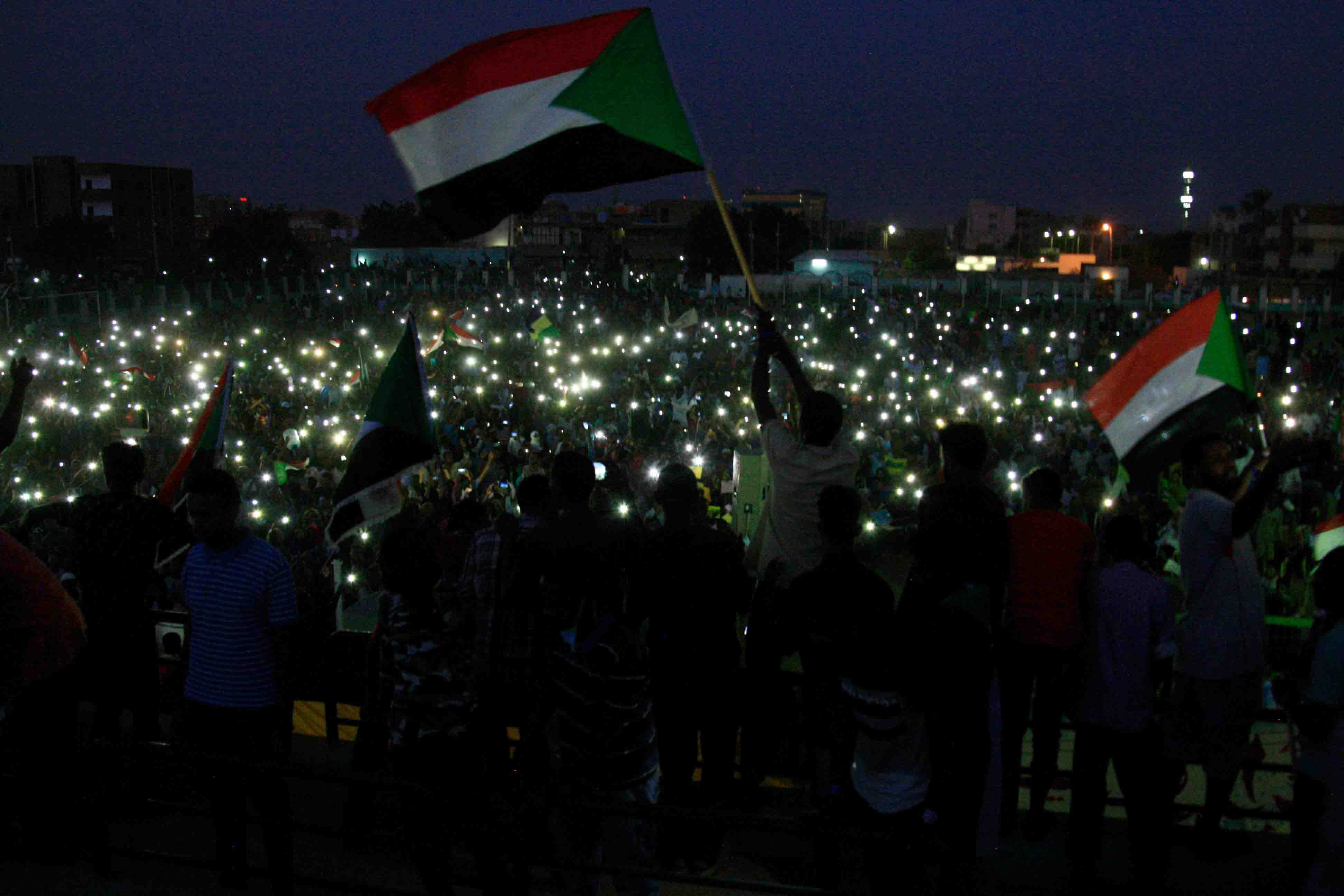 Groups of protesters sat in circles around Sudanese flags and candles in several neighbourhoods as the sun set over Khartoum.