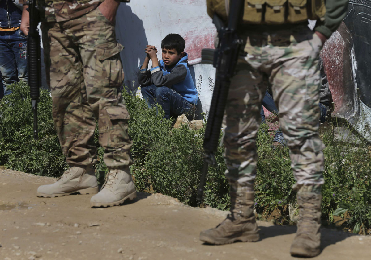 A Syrian refugee boy watches the opening ceremony of a school for Syrian refugees