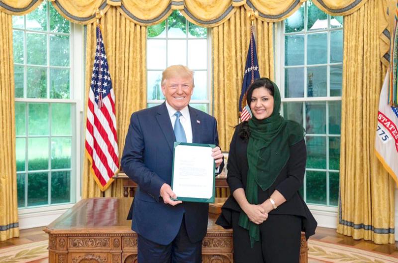 Saudi Arabia’s new Ambassador to the United States Princess Reema bint Bandar bin Sultan (R) presents her credentials to US President Donald Trump in Washington