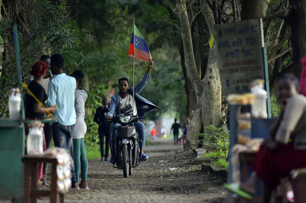 A young man rides a motorcycle along a parkway in Awasa, southern Ethiopia