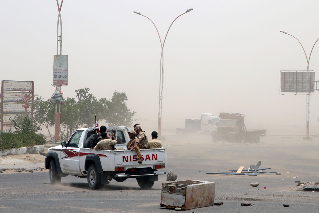 Members of UAE-backed southern Yemeni forces patrol a road during clashes with government forces in Aden, Yemen