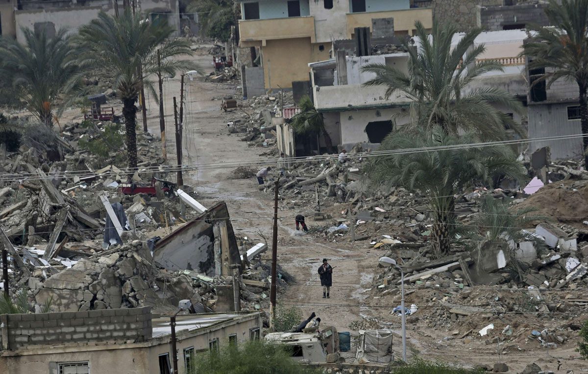 Egyptian army forces patrol amid the debris of houses destroyed by the army in the town of Rafah