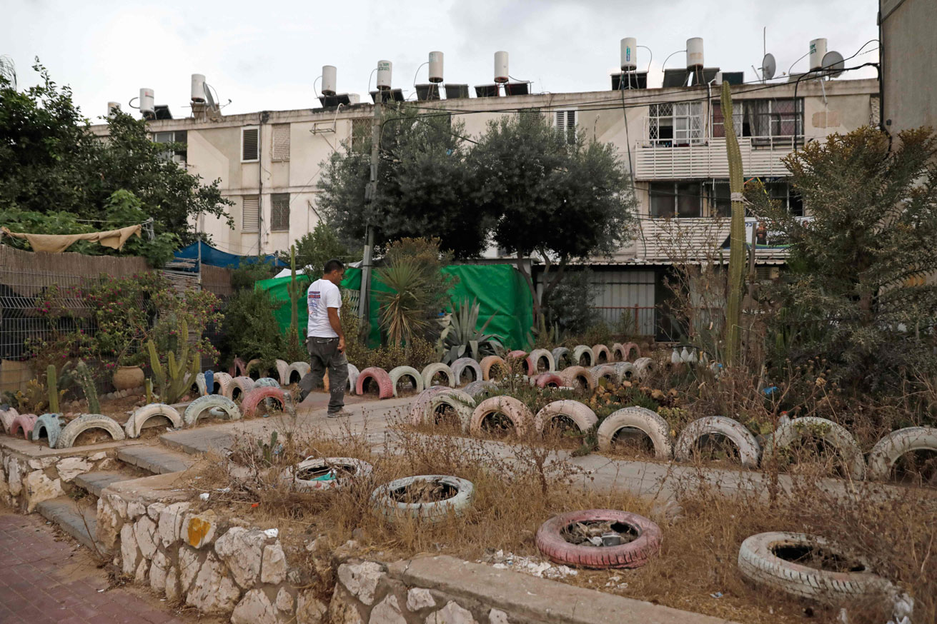 A man walks in an impoverished neighbourhood in the city of Ashkelon