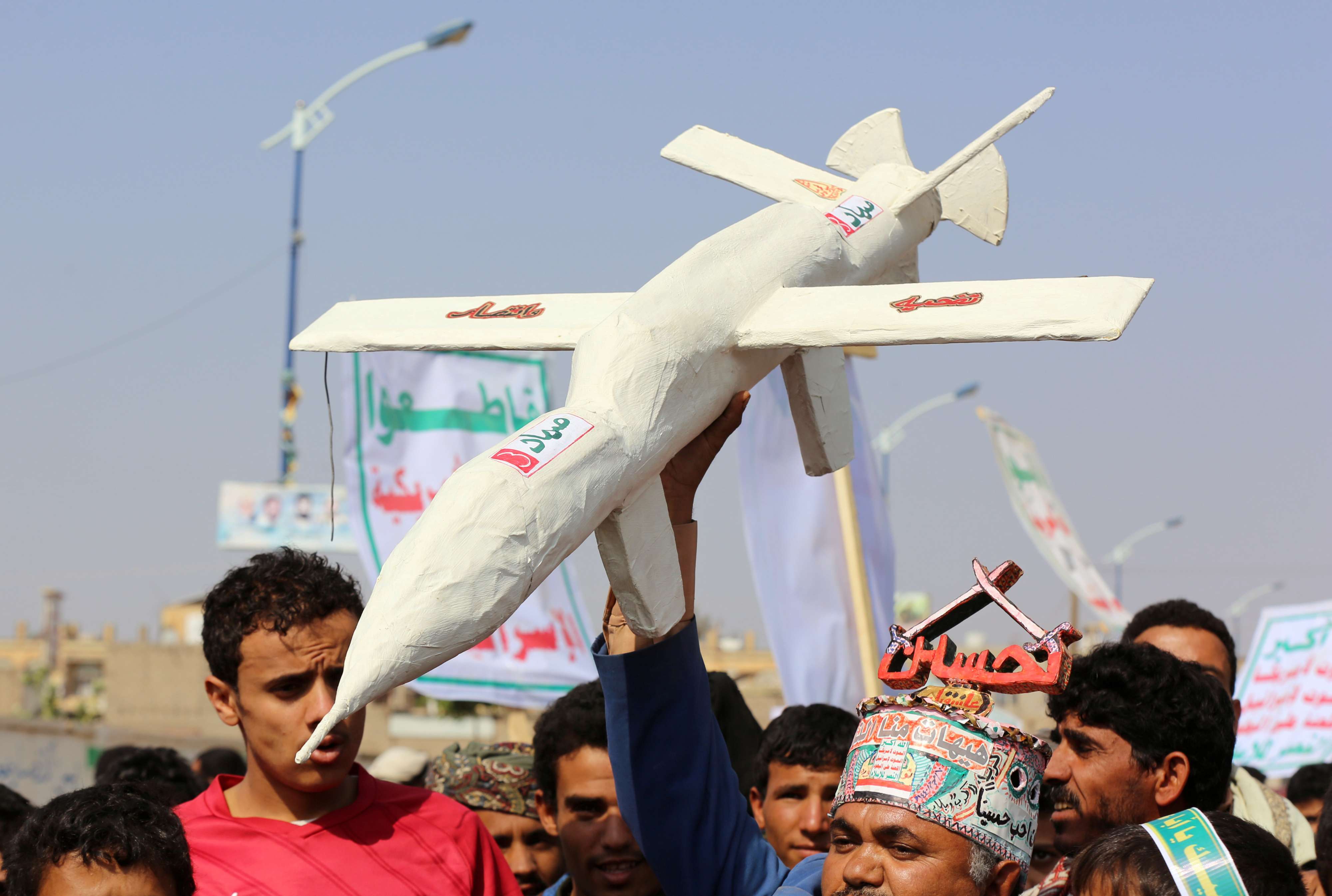 Followers of the Huthi movement carry a mock drone during a rally held to mark Ashura in Saada, Yemen