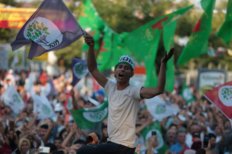 A supporter of the pro-Kurdish Peoples' Democratic Party (HDP) waves a party flag during a peace day rally in Diyarbakir