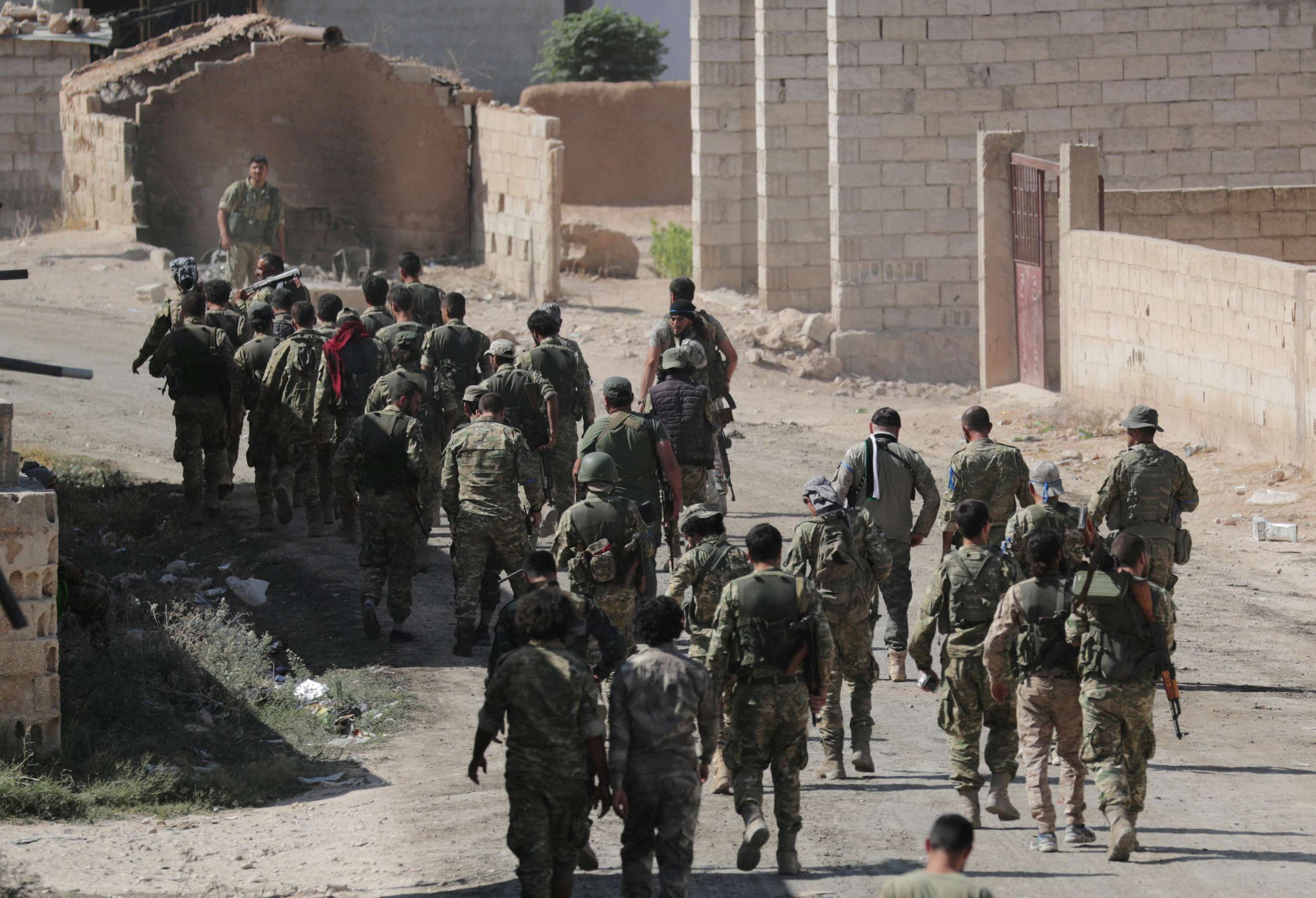 Gunfire resounded early on Sunday around Ras al Ain, one of two Syrian towns which are the focus of the attack