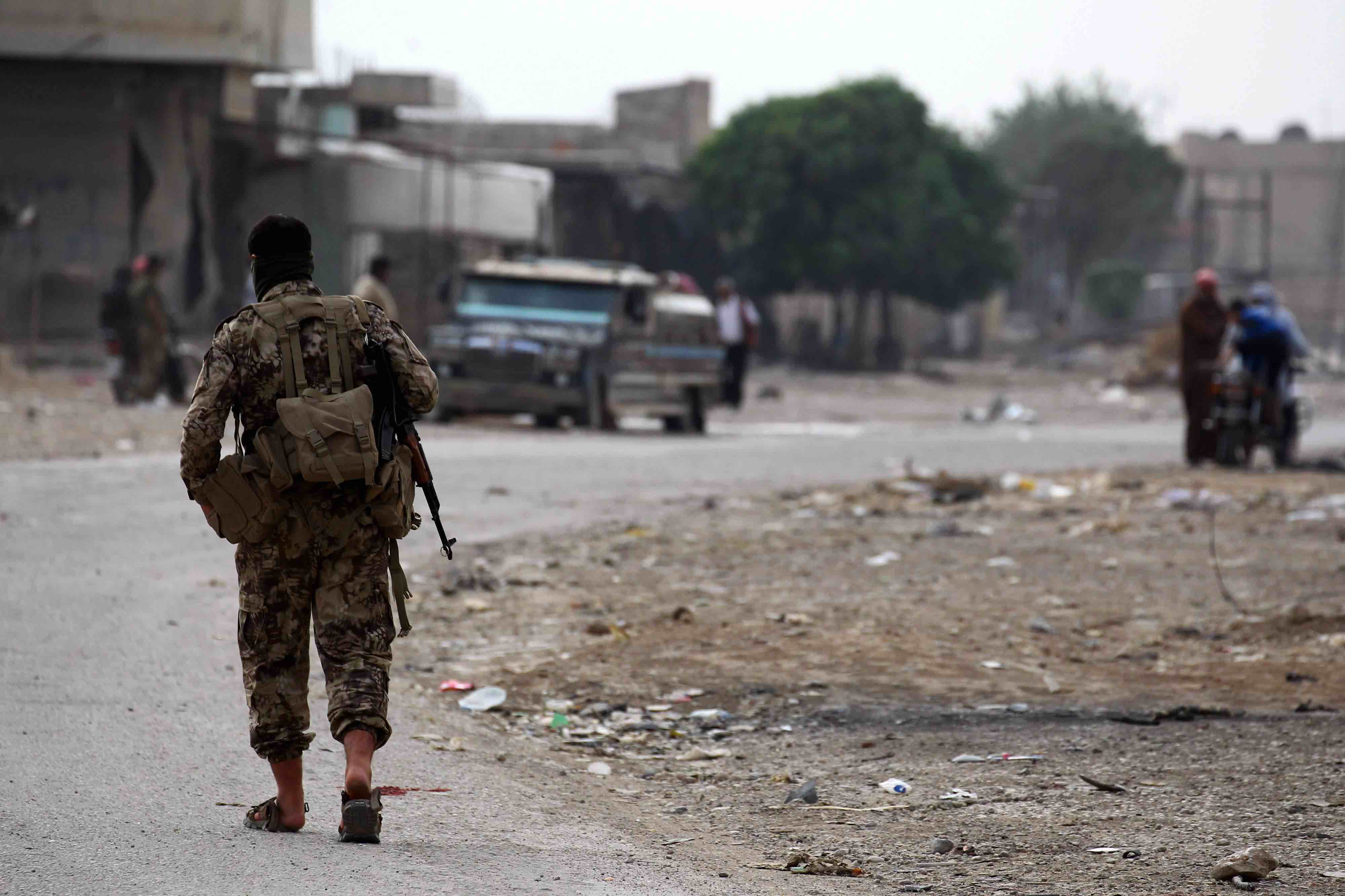 Dozens of fighters in military attire left on pickups, passing by checkpoints manned by Ankara-allied Syrian fighters, the reporter said.