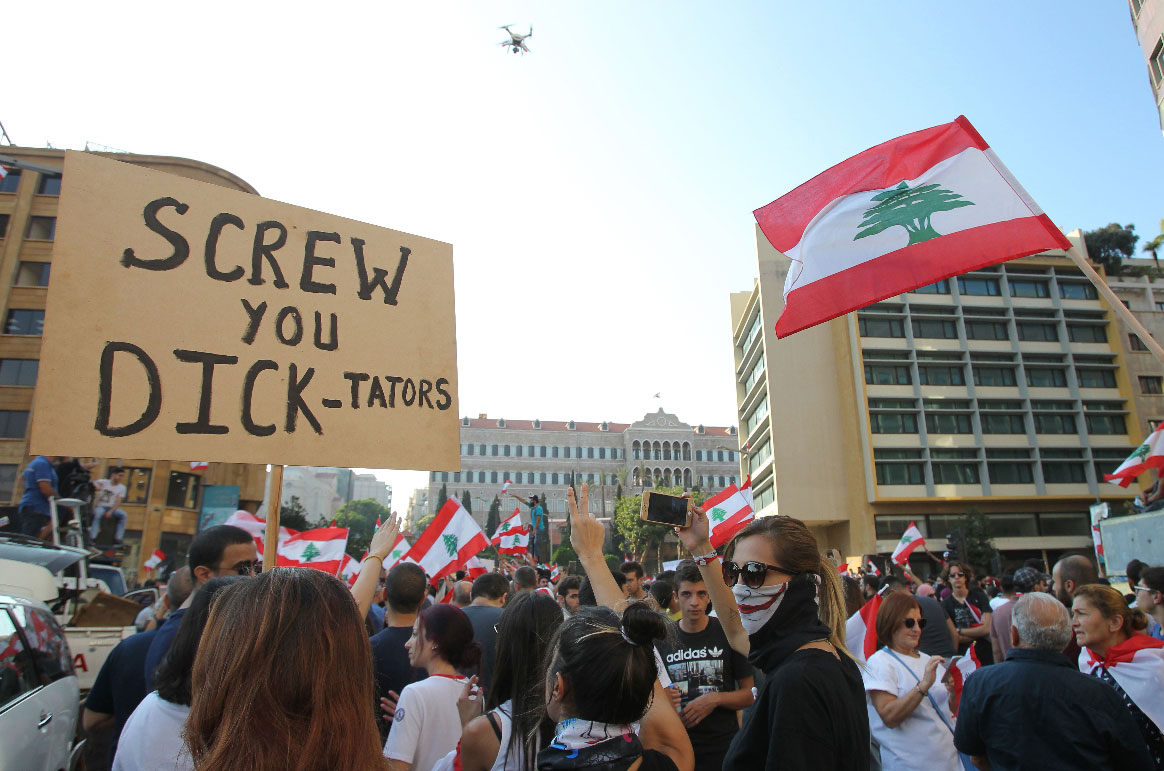 Lebanese demonstrators take part in a protest against dire economic conditions in Lebanon's southern city of Sidon