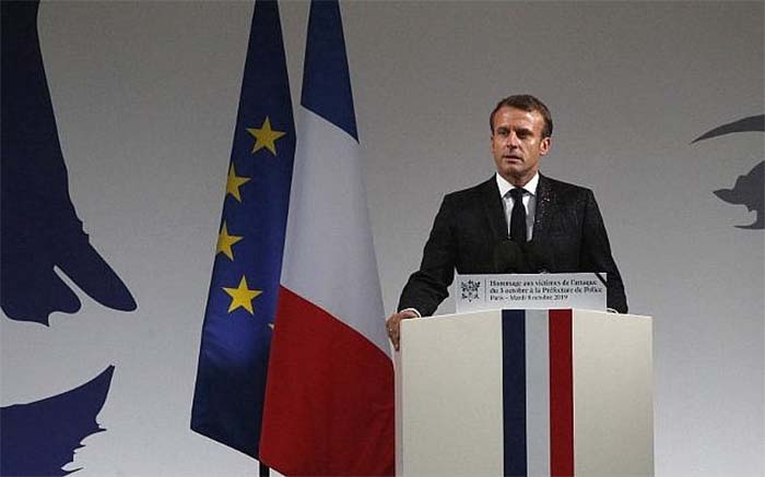 Macron addressing a ceremony at the Paris police headquarters where the attack took place