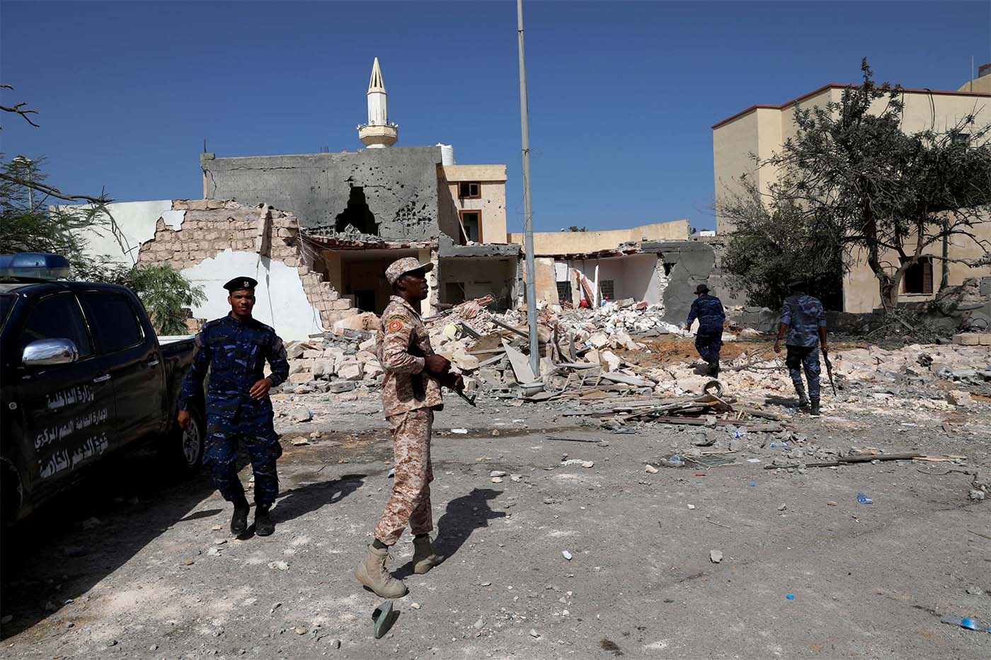 Security members inspect the site of the air strike