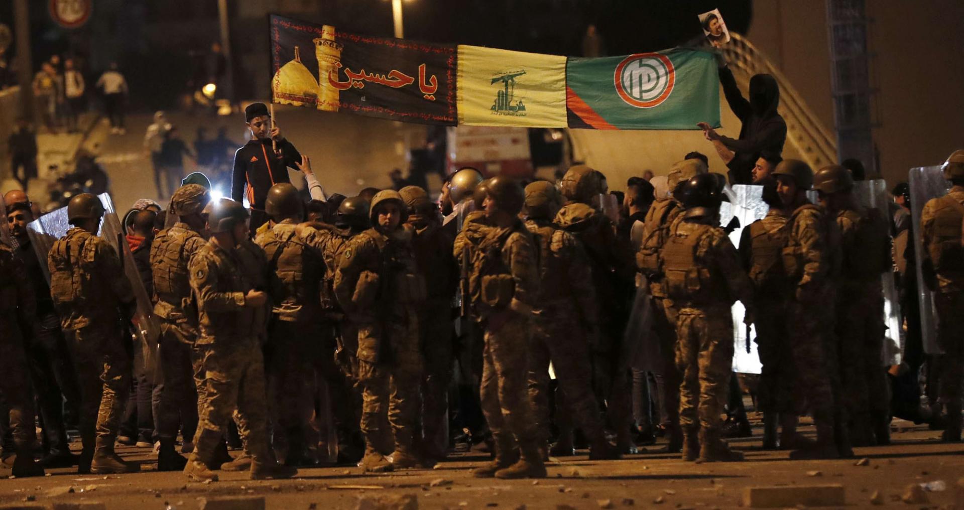 Army soldiers and riot police formed a barrier separating the protesters from the supporters of the Shi'ite groups