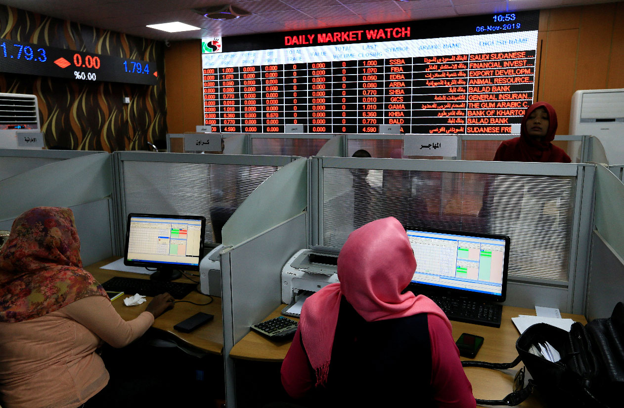 Women work at the Khartoum Stock Exchange in Khartoum, Sudan