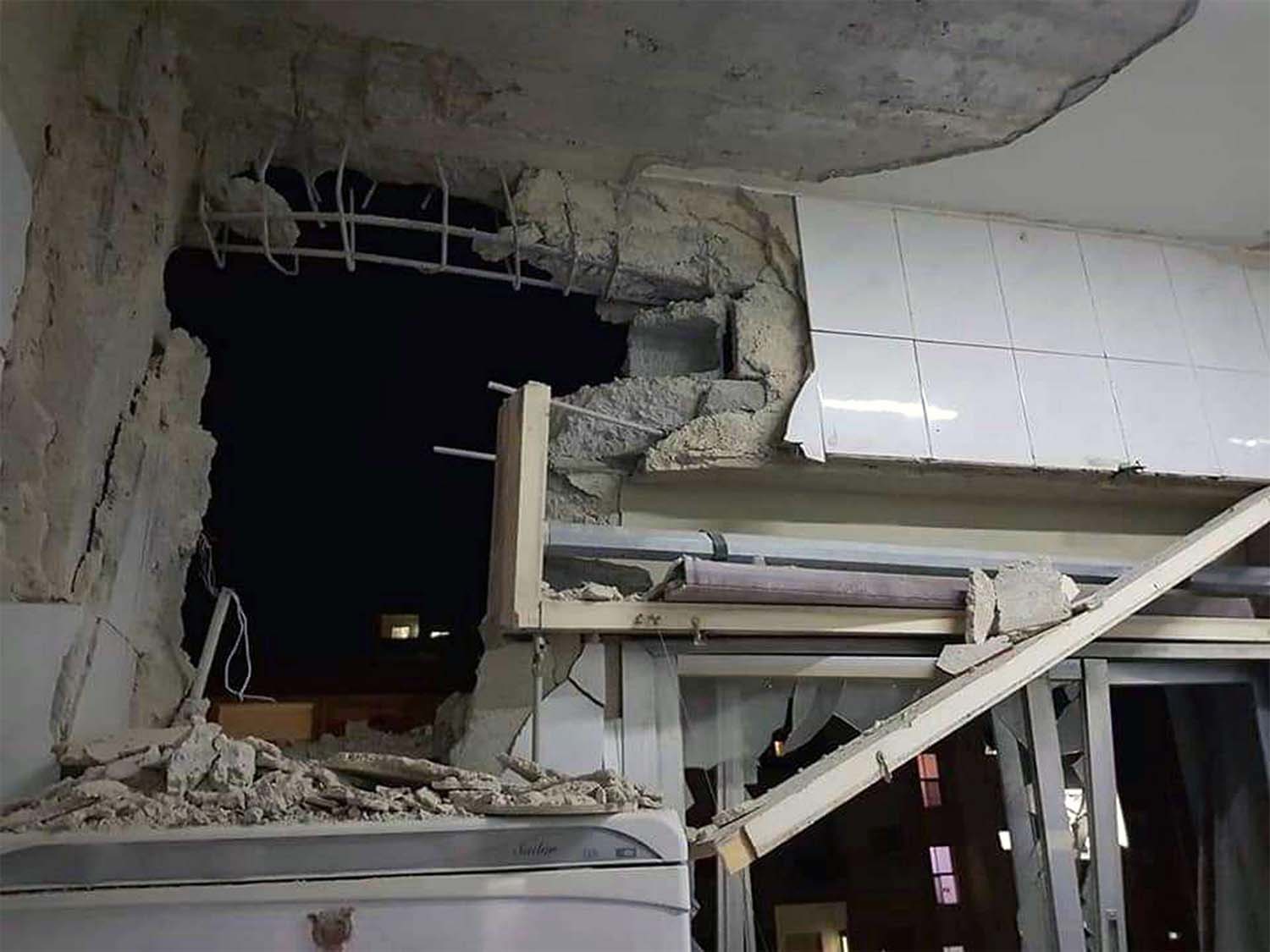 A damaged building targeted by Israeli missile strikes in Qudsaya suburb