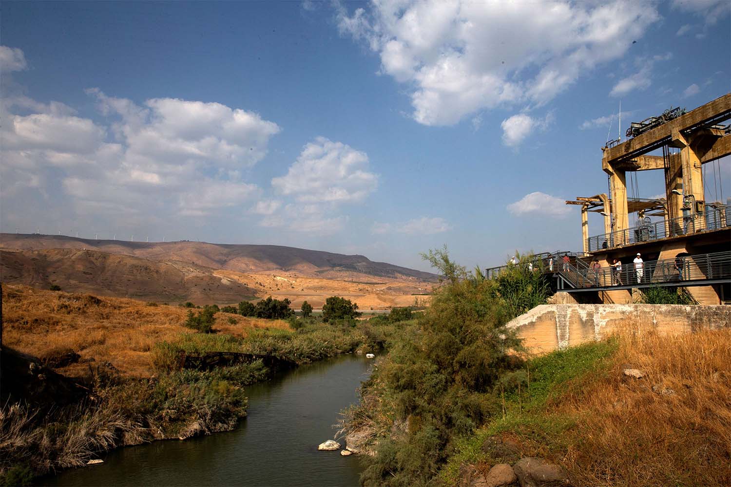 A general view show visitors at an abandoned hydroelectric power plant in the border area between Israel and Jordan near Naharayim 