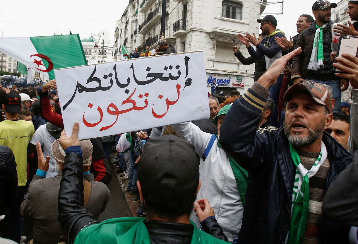 Banner raised at anti-government protests in Algiers reads "your elections will not take place"