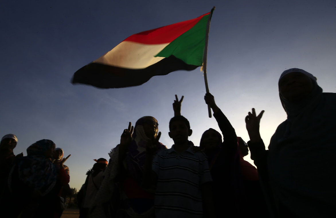 Demonstrators wave the Sudanese flag in Khartoum
