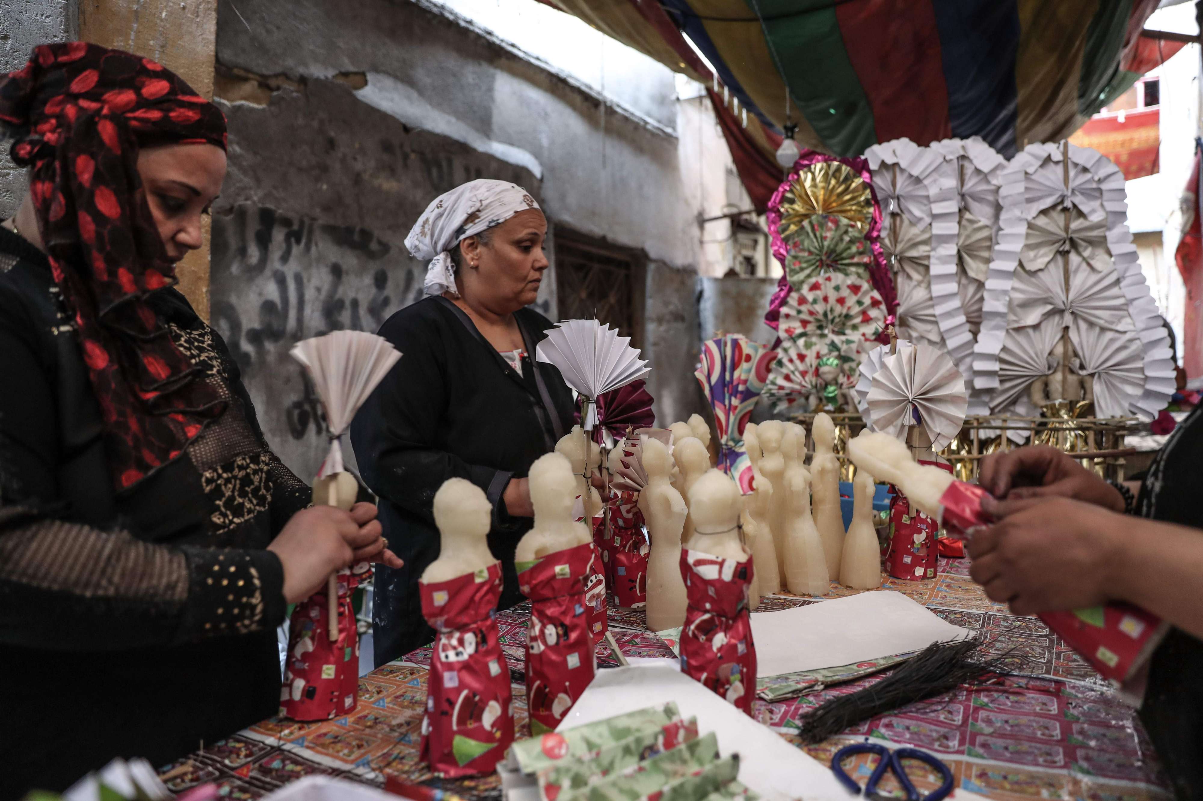  Egyptian women decorate traditional sugar statuettes in the capital Cairo