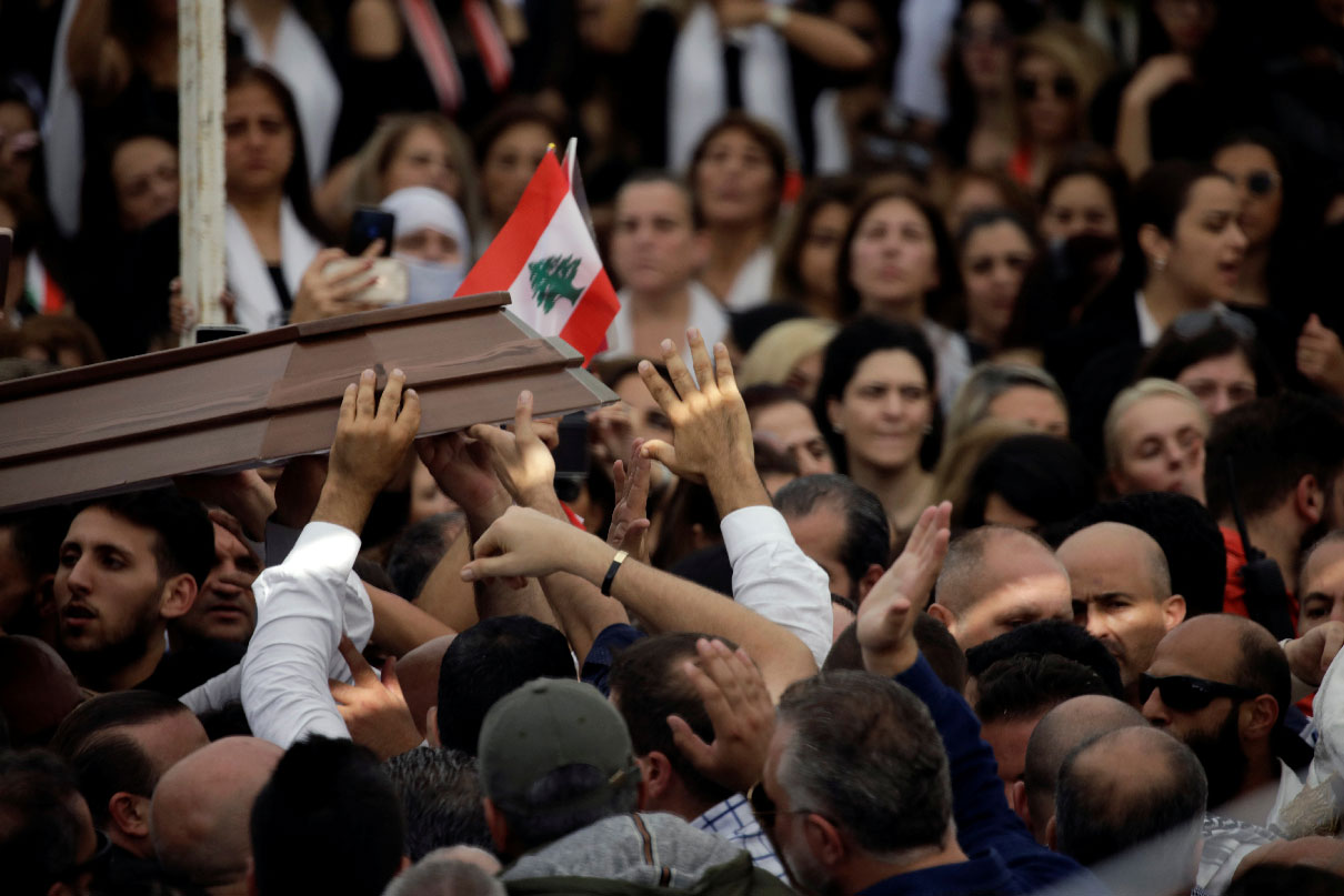 Mourners carry the cover of the coffin of Alaa Abou Fakher during the funeral in Choueifat
