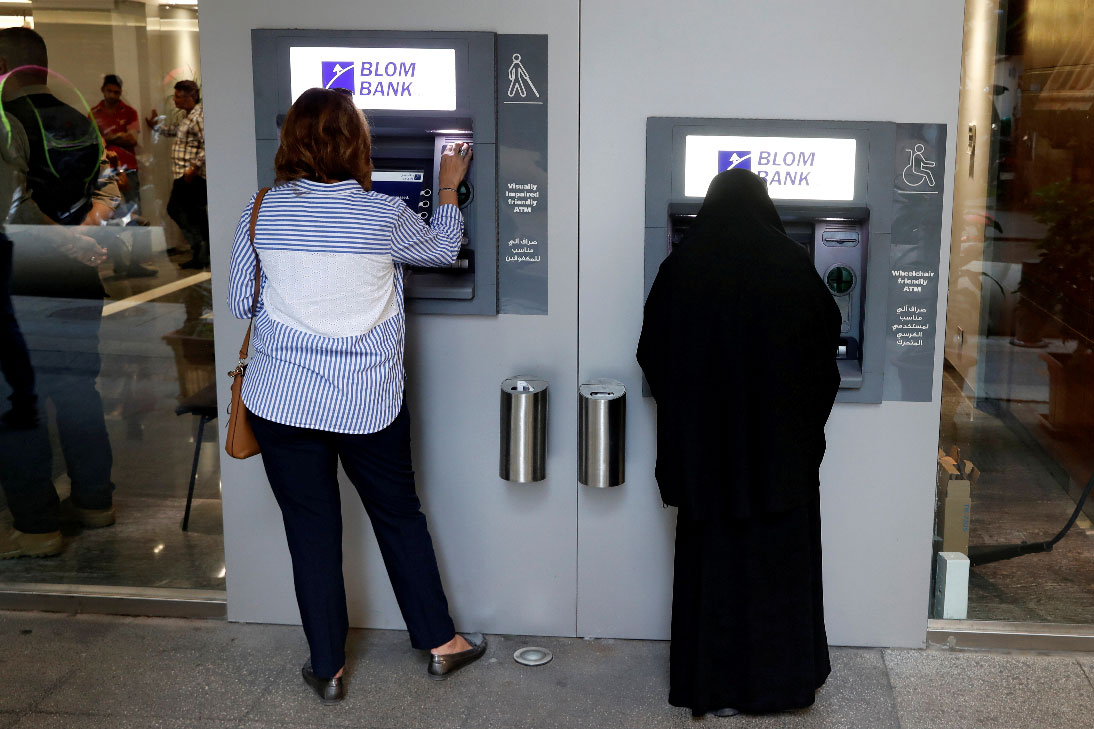 Women use ATMs at Blom bank in Beirut