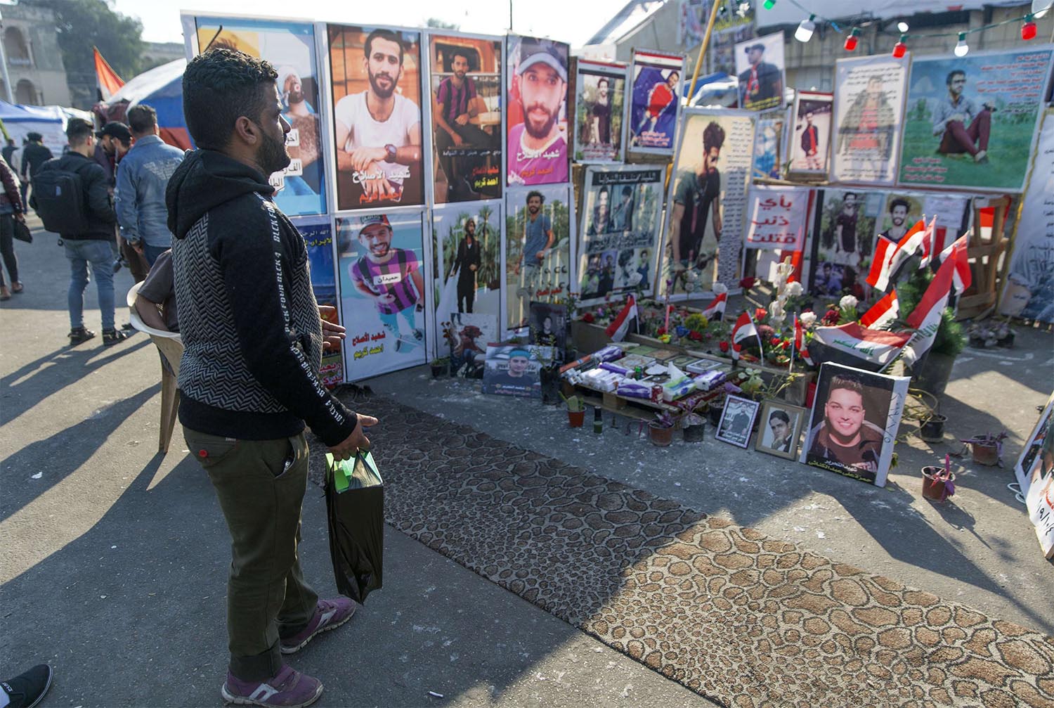 Symbolic graves adorned with names and pictures of anti-government protesters, who have been killed in protests at Baghdad's Tahrir Square