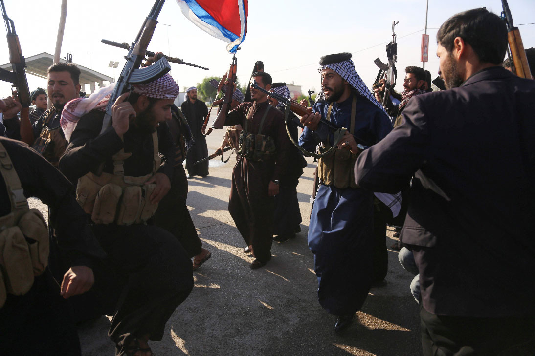 Armed tribe members take to the streets in Iraq's southern, holy city of Karbala