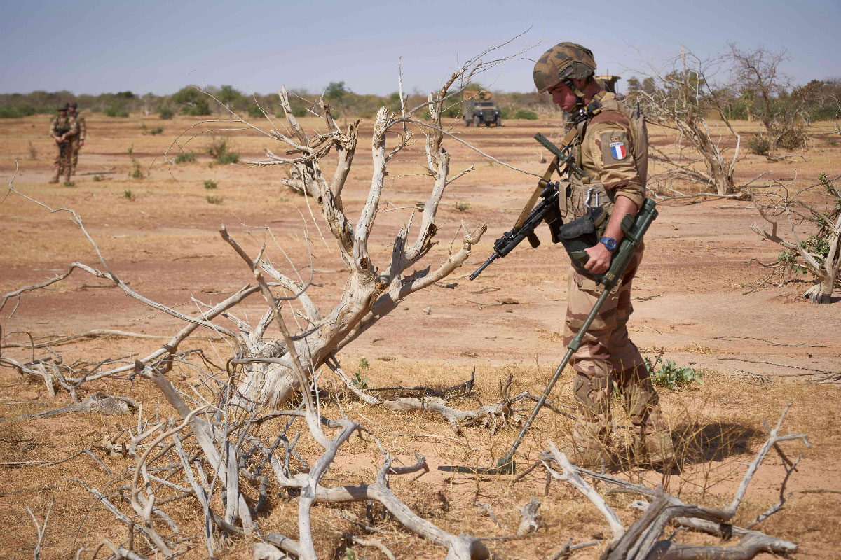 A French soldier holds a detector while searching for the presence of IEDs in northern Burkina Faso