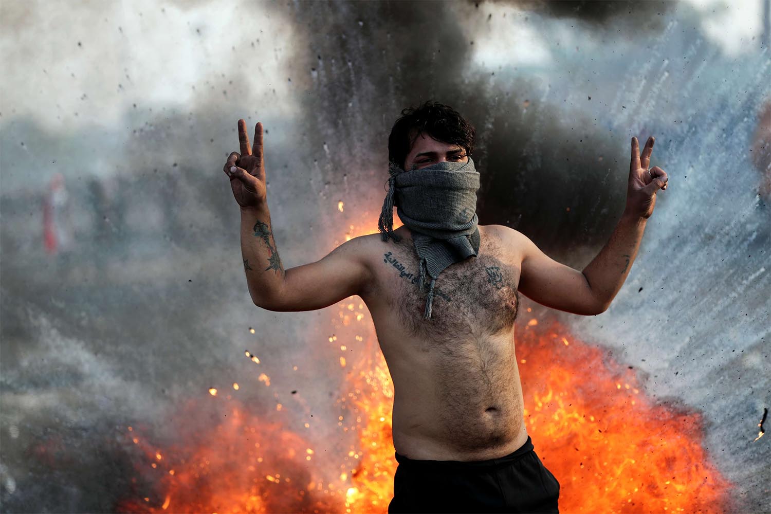 An Iraqi demonstrator gestures during ongoing anti-government protests in Baghdad