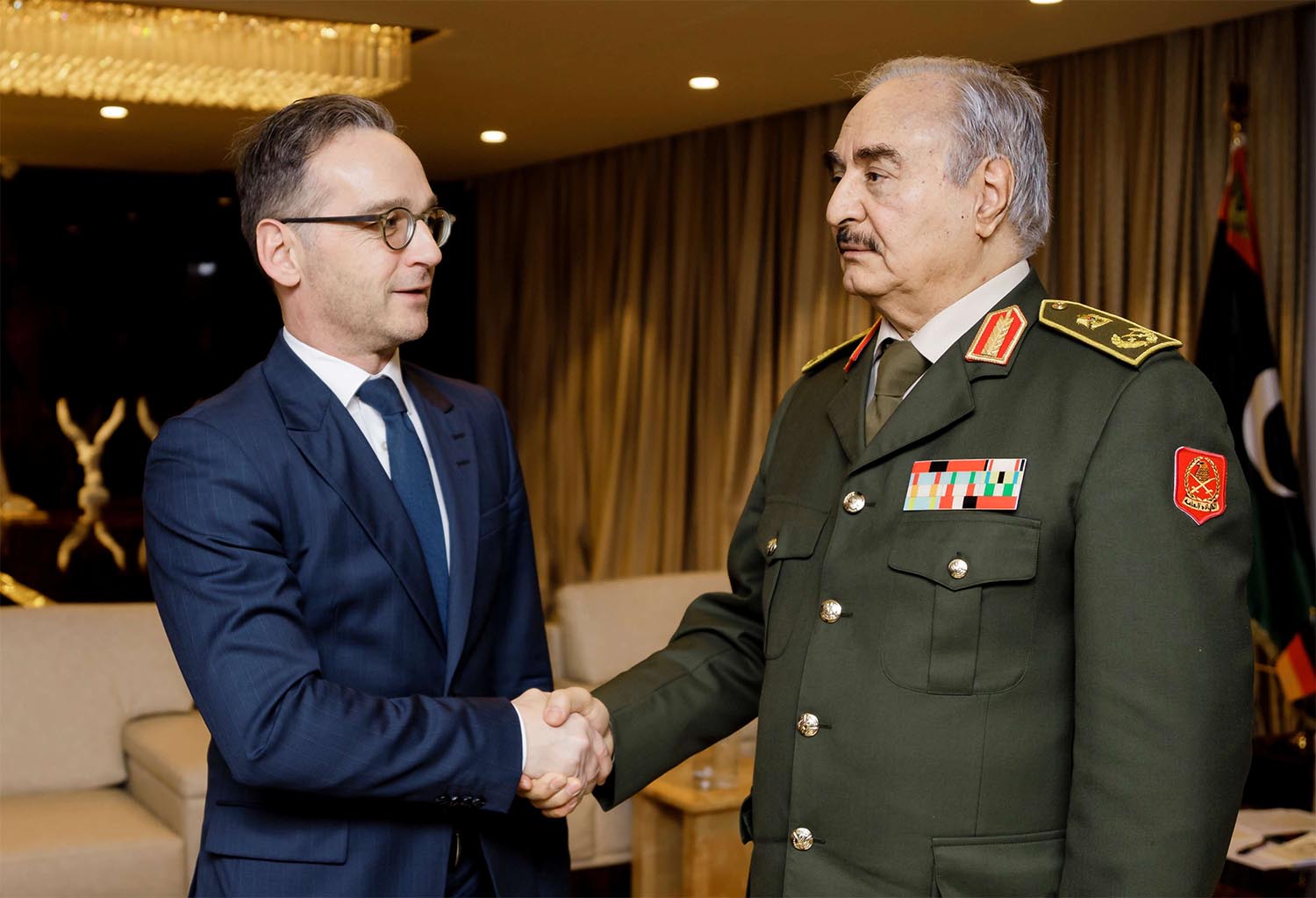 German Foreign Minister Heiko Maas shakes hands with Libya's commander Khalifa Haftar in Benghazi
