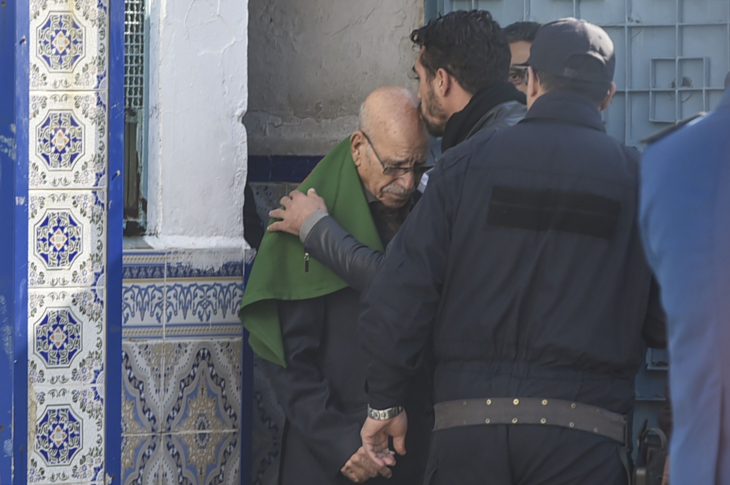 A relative kisses the head of Algerian war veteran Lakhdar Bouregaa upon his release in Algiers