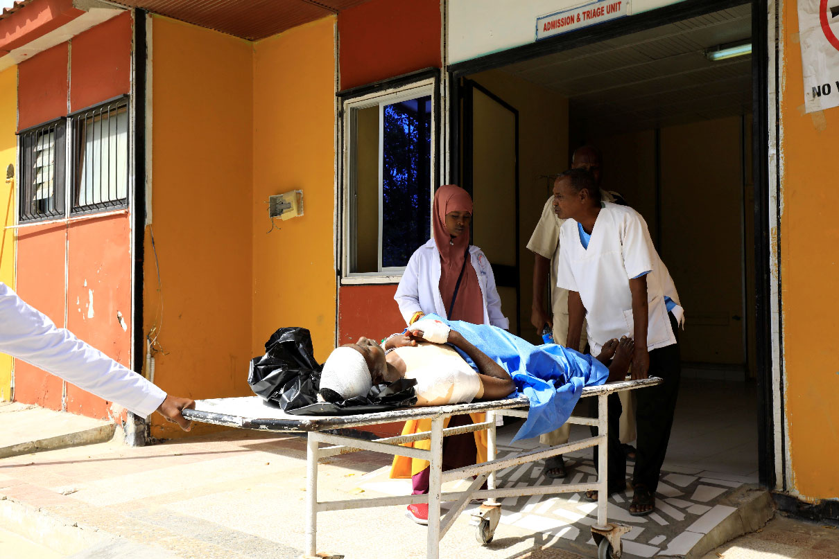 Paramedics at the Madina hospital assist an unidentified man injured in an explosion in Afgoye