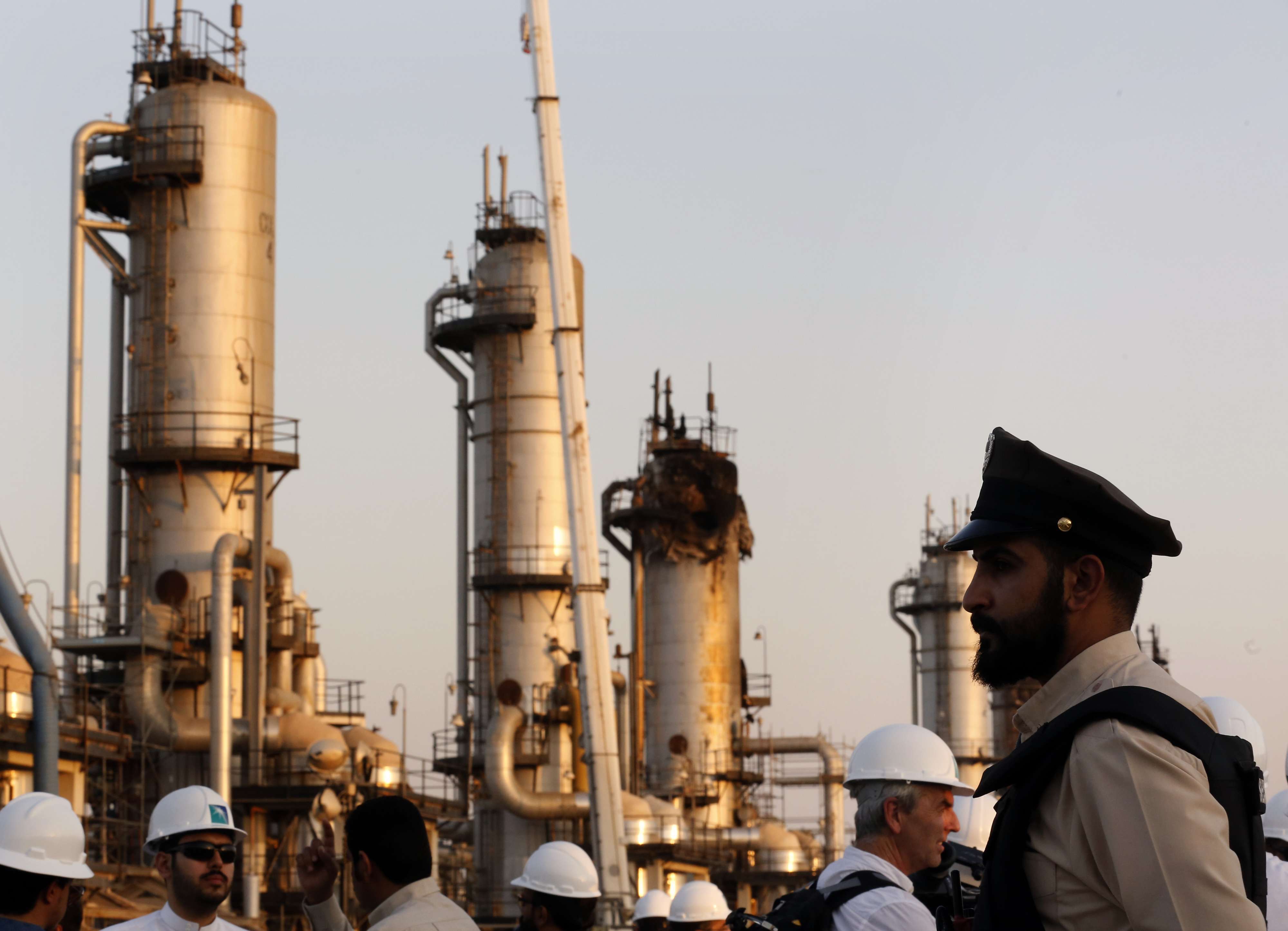 A security guard stands alert in front of Aramco's oil processing facility