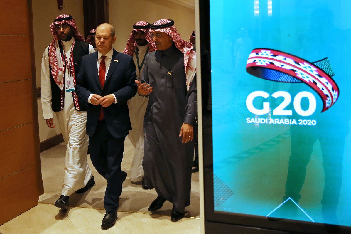 German Finance Minister Olaf Scholz and Saudi Minister of Finance Mohammed al-Jadaan walk to the G20 finance ministers and central bank governors meeting hall in Riyadh