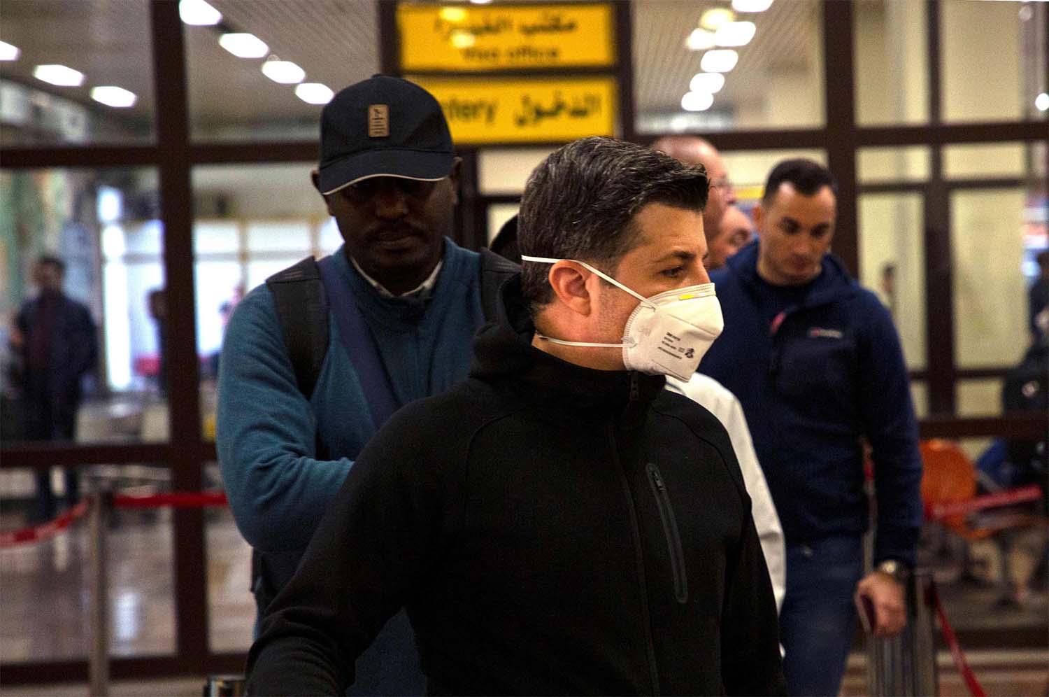 A passenger wearing a mask is pictured at Basra airport in southern Iraq