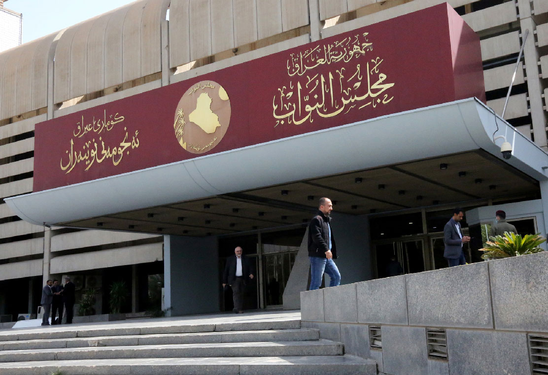 Iraqis stand outside parliament building, or Council of Representatives, in Baghdad's Green Zone