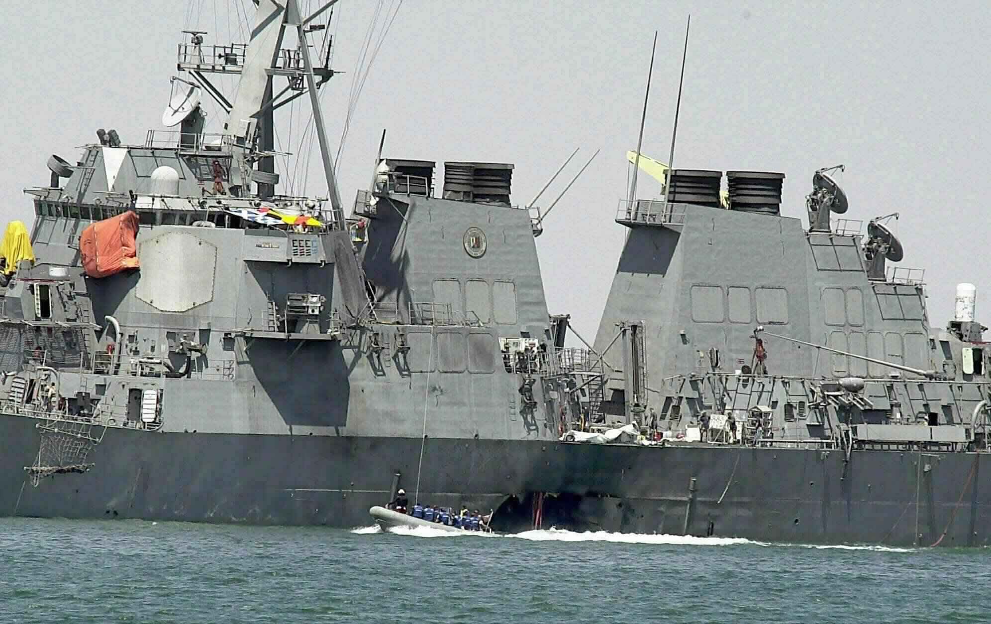 Oct. 15, 2000 file photo shows experts in a speed boat examining the damaged hull of the USS Cole at the Yemeni port of Aden