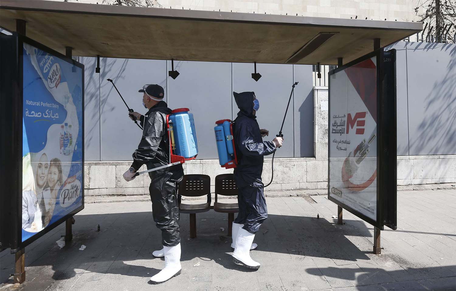 Syrian municipal workers spray disinfectant against the COVID-19 coronavirus in Damascus 