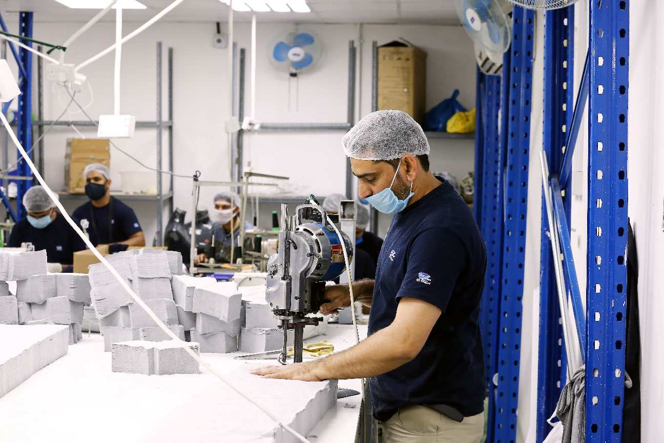 A worker sews pieces of cloth to make face masks at a factory, following the outbreak of coronavirus disease (COVID-19), in Ajman, United Arab Emirates
