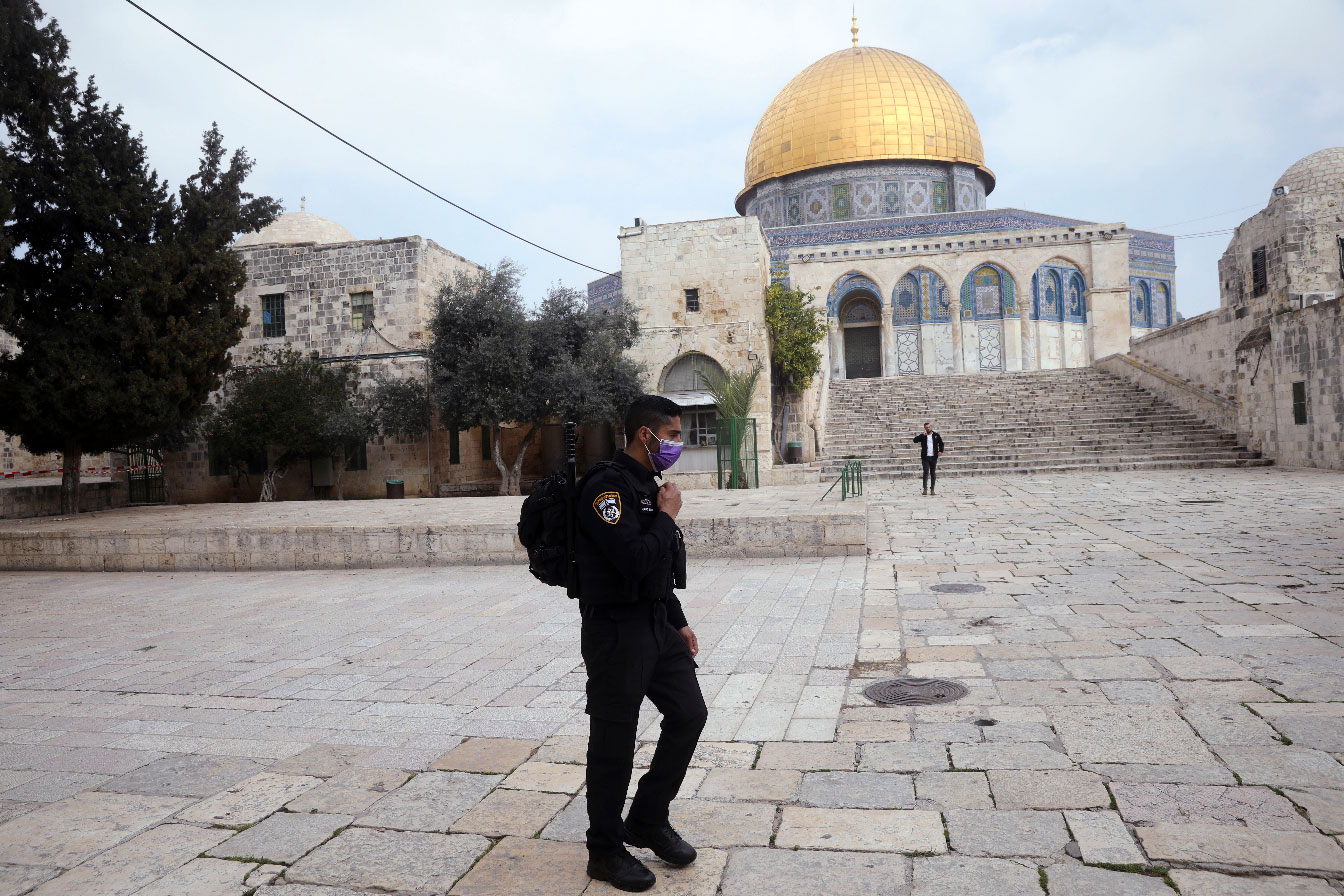 Israeli policeman walks in front of the Dome of the Rock in occupied East Jerusalem