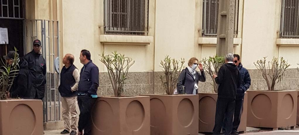 A woman wearing a protective mask outside the Italian school in Casablanca