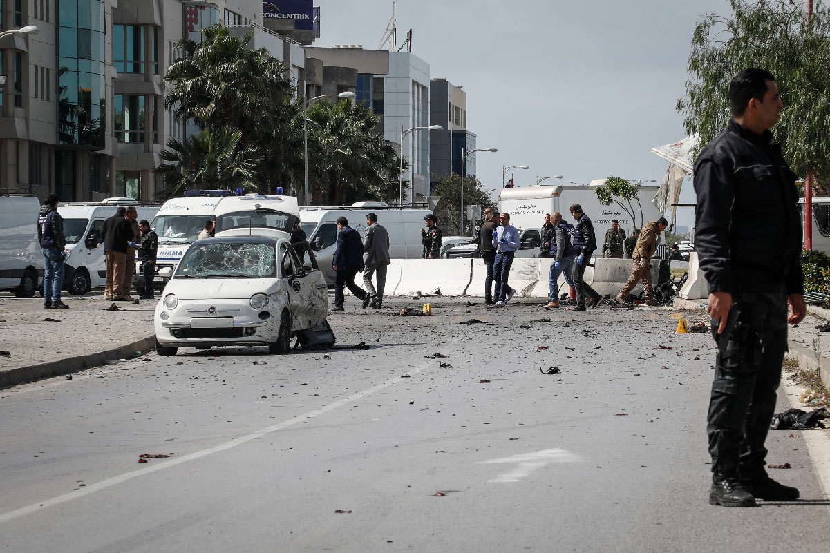 An armed Tunisian police officer at the site of an explosion near the US embassy