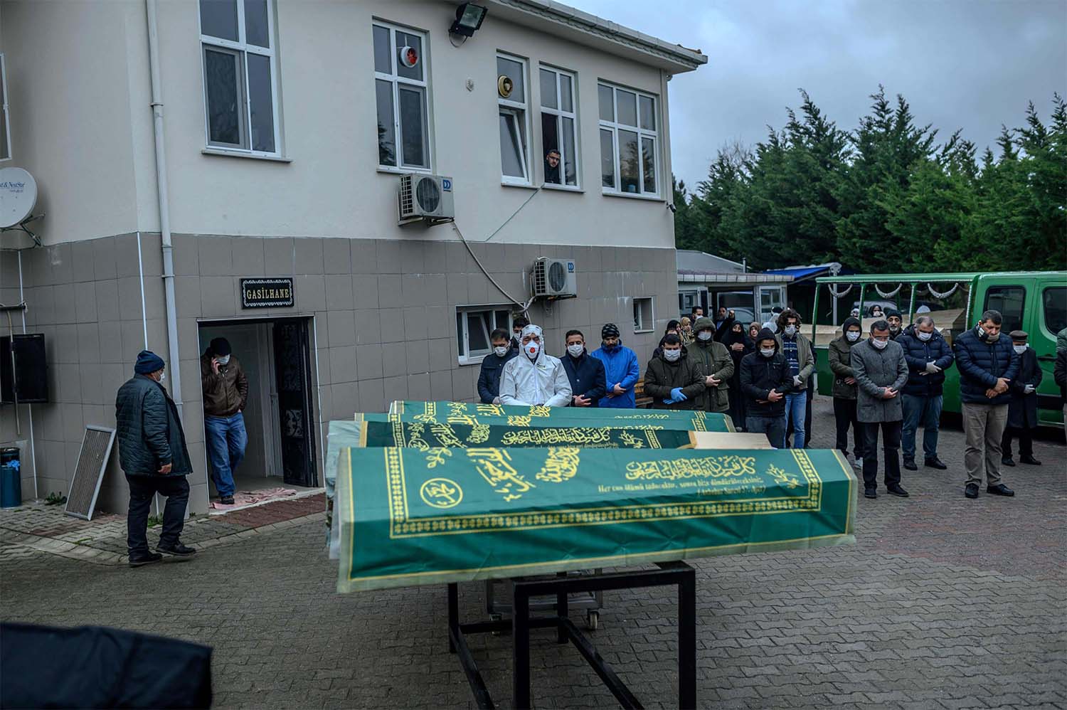Coffins of people who officially died of contagious diseases are displayed in front of relatives and officials