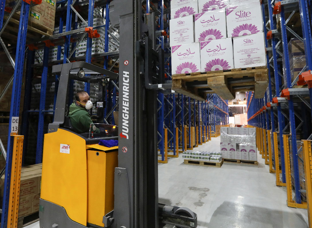 A worker wears a protective face mask as he works at Bohsali food warehouse