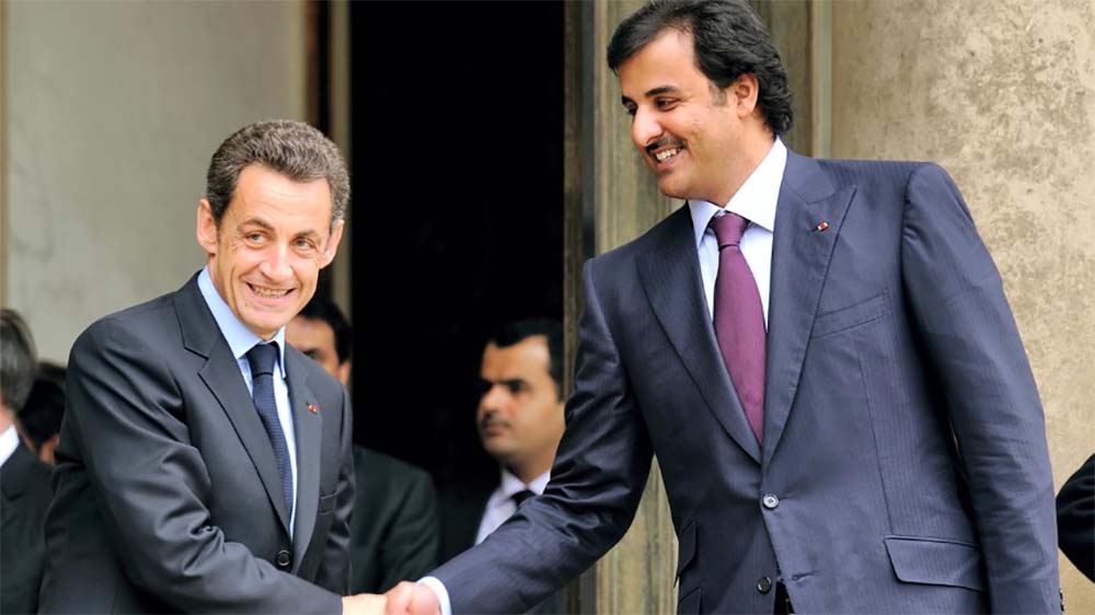 Fromer French President Sarkozy shaking hands with Qatar's emir