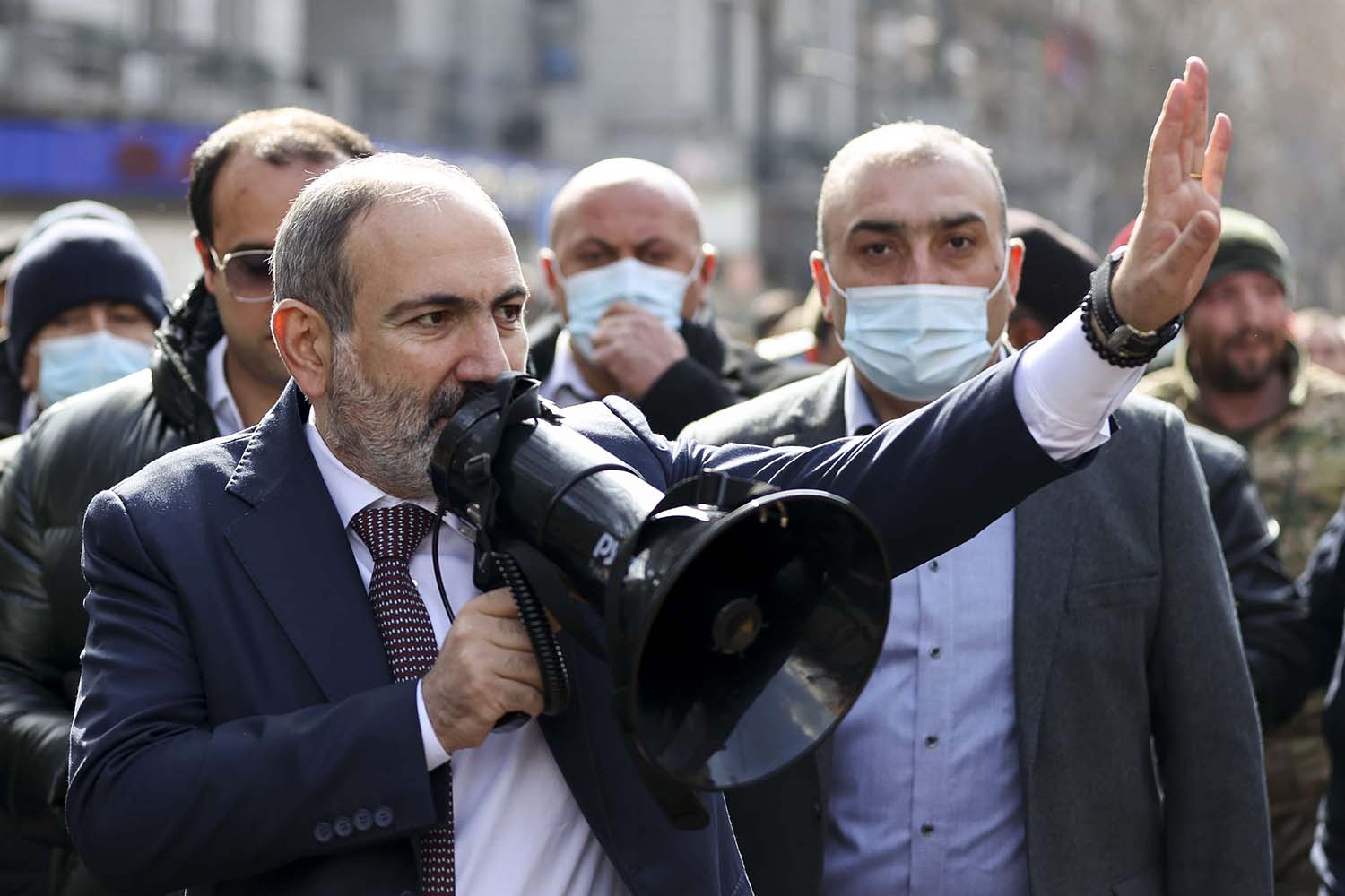 Armenian Prime Minister Nikol Pashinyan gestures speaking to a crowd in the center of Yerevan