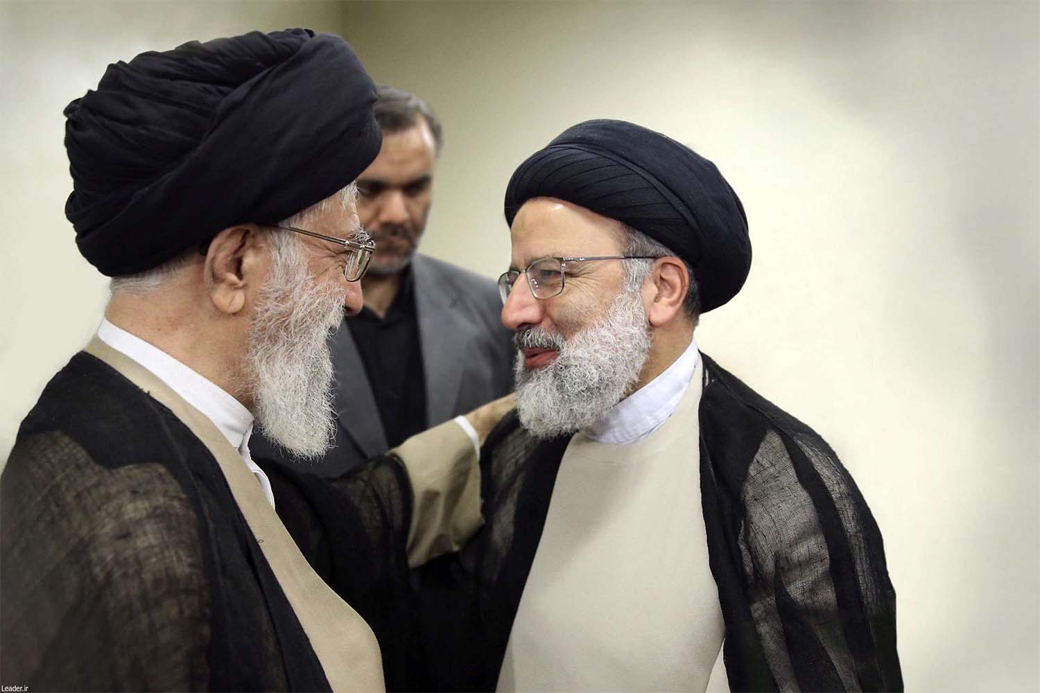 ranian Supreme Leader Ayatollah Khamenei talks to Ebrahim Raisi