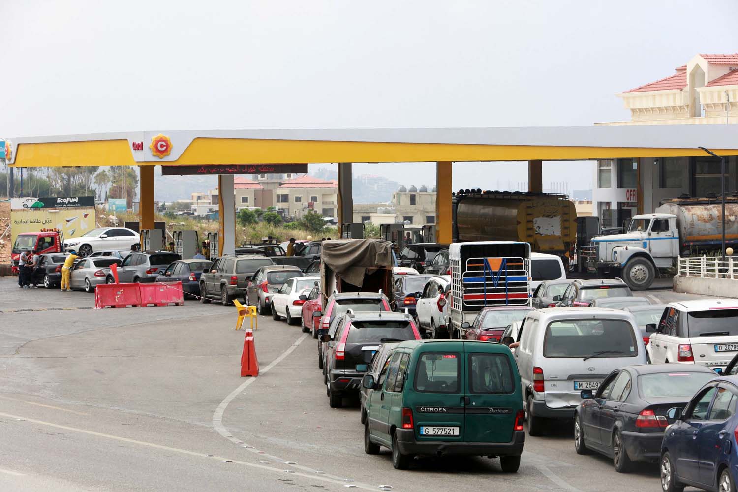 Cars stand in line at a gasoline station in Jiyeh, Lebanon