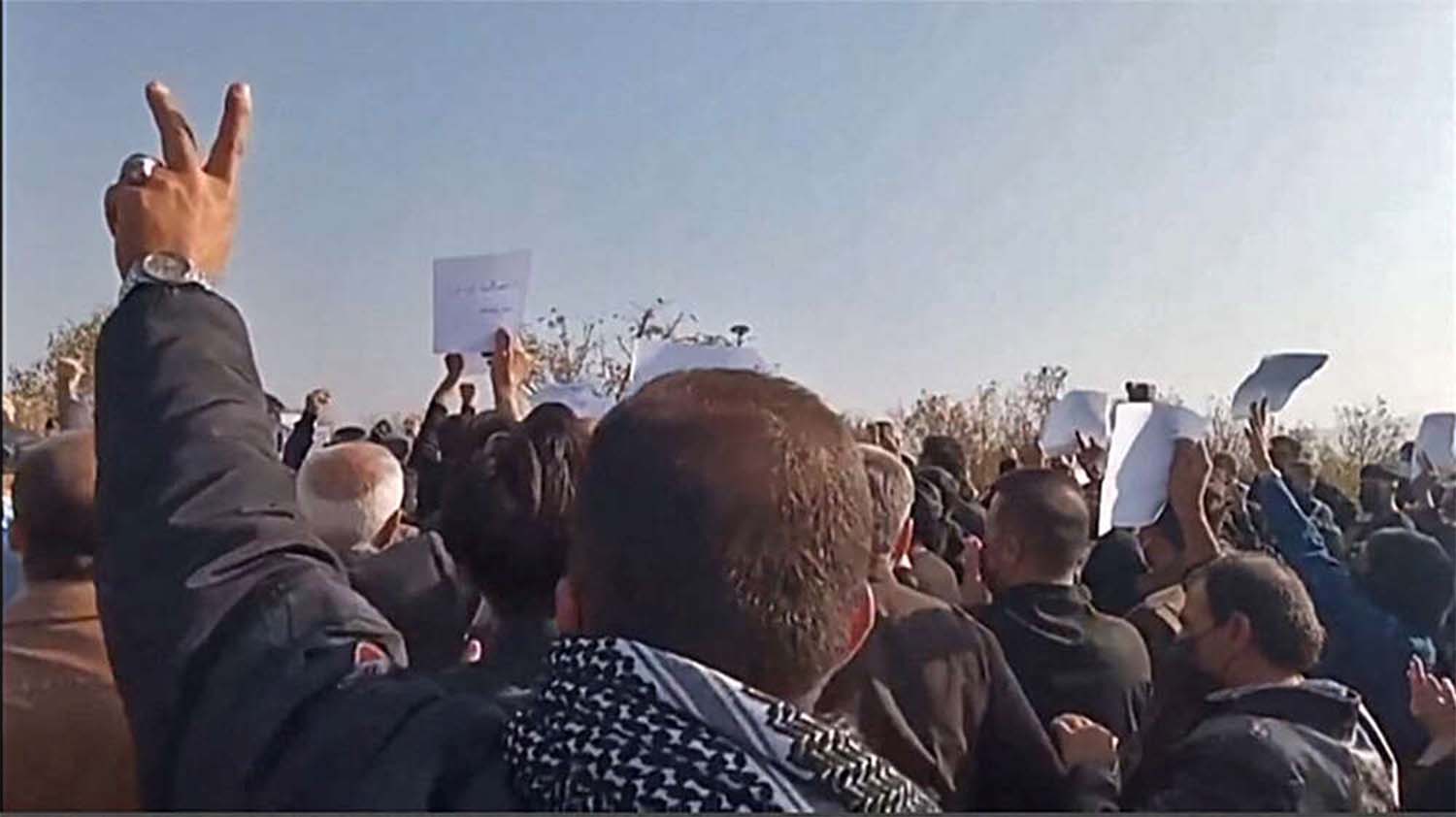 Crowds snaked through the local cemetery and thronged Amini’s grave