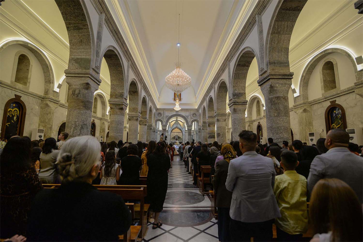 Iraqi Catholic Christians attending Easter Sunday mass at Qaraqosh's Al-Tahera (Immaculate Conception) Church in the Hamdaniyah district in the northern Iraqi province of Nineveh last April