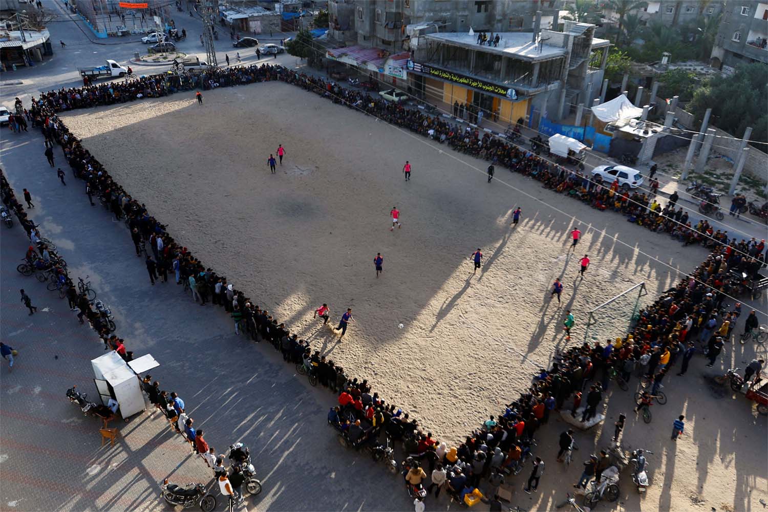 Young Palestinian men play football during tRamadan in Rafah 